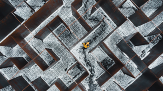 person lost in maze or dark iron walls.